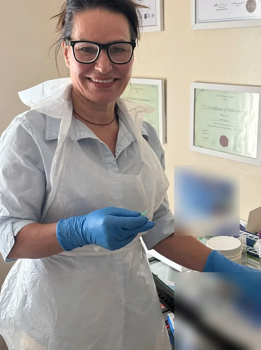 Mel Barge smiling in her Oakham treatment room, preparing a treatment